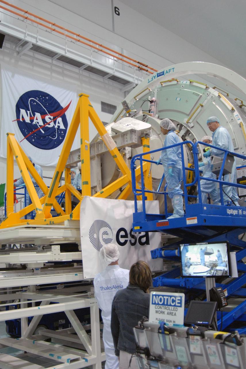 CAPE CANAVERAL, Fla. – In NASA Kennedy Space Center's Space Station Processing Facility,  the Cupola module is being mated to the Tranquility node on the work stand.  Cupola and Tranquility are the payload for space shuttle Endeavour's STS-130 mission to the International Space Station. The module was built for the European Space Agency by Alenia Spazio in Turin, Italy. When attached to the Tranquility Node 3 module, Cupola will resemble a circular bay window that will provide a vastly improved view of the station's exterior. Just under 10 feet in diameter, the module will accommodate two crew members and portable workstations that can control station and robotic activities. The multi-directional view will allow the crew to monitor spacewalks and docking operations, as well as provide a spectacular view of Earth and other celestial objects.  Endeavour is targeted to launch Feb. 4, 2010.   Photo credit: NASA/Cory Huston