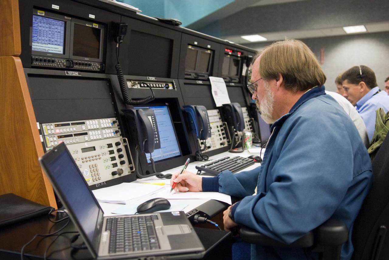 CAPE CANAVERAL, Fla. – In Firing Room 1 at NASA's Kennedy Space Center in Florida, mission engineers take part in a countdown simulation for the upcoming Ares I-X flight test. Ares I-X is targeted for the test on Oct. 31. In the foreground is George Odom. Seen in the back is Jeremy Graeber. Photo credit: NASA/Kim Shiflett