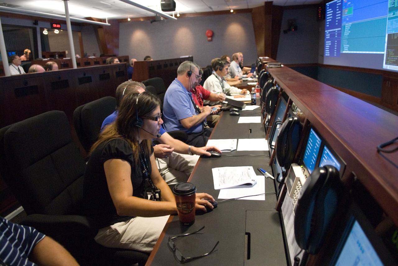 CAPE CANAVERAL, Fla. – In the Mission Director Center in Cape Canaveral Air Force Station's Hangar AE, mission engineers take part in a countdown simulation for the upcoming Ares I-X flight test.  Ares I-X is targeted for the  test on Oct. 31.  The Hangar AE control rooms provide real-time voice, data and video information for ex¬pendable vehicle checkout and launch operations, similar to that provided by the space shuttle control rooms.  Photo credit: NASA/Kim Shiflett