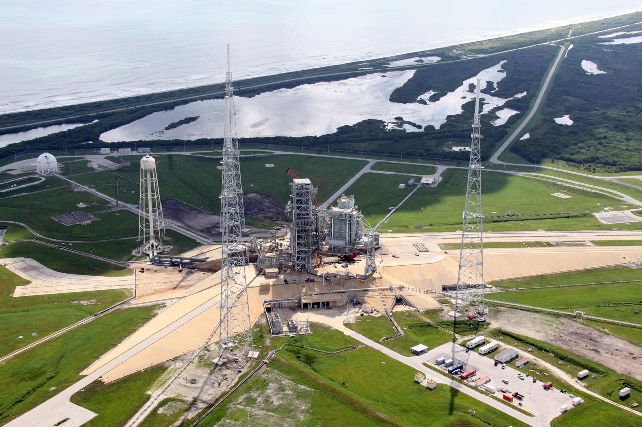 CAPE CANAVERAL, Fla. – An aerial view of NASA Kennedy Space Center's Launch Pad 39B. The pad is surrounded by lightning towers erected for NASA's Constellation Program, which will use the pad for Ares rocket launches. At the top is the Atlantic Ocean. Photo credit: NASA/Troy Cryder