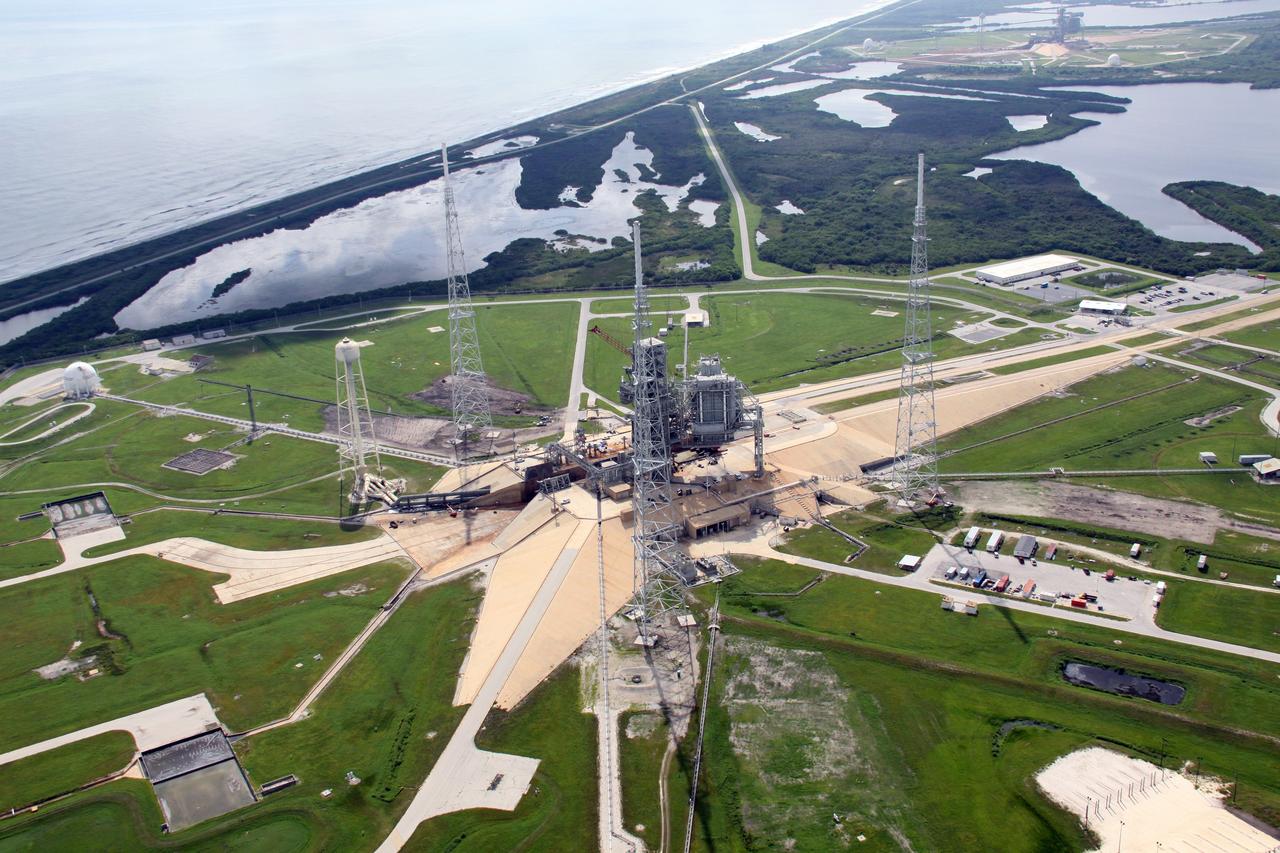 CAPE CANAVERAL, Fla. – An aerial view of NASA Kennedy Space Center's Launch Pad 39B. The pad is surrounded by lightning towers erected for NASA's Constellation Program, which will use the pad for Ares rocket launches. At the top is the Atlantic Ocean. Photo credit: NASA/Troy Cryder