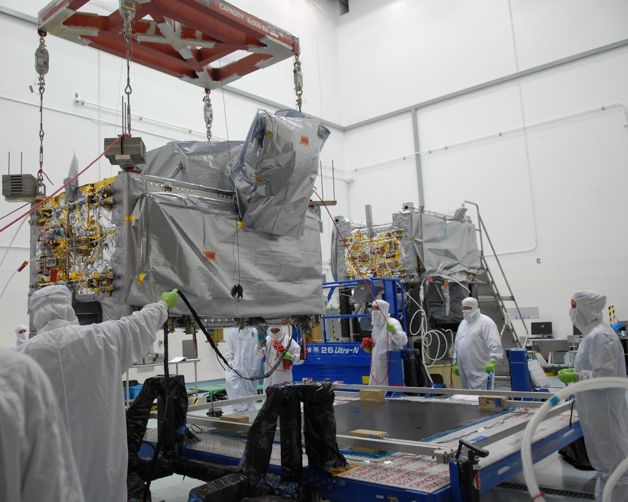CAPE CANAVERAL, Fla. – At the Astrotech payload processing facility in Titusville, Fla., a crane moves the SV1 spacecraft, which will be mated with the SV2 at right.  The two spacecraft are part of the Space Tracking and Surveillance System – Demonstrators, or STSS Demo, Program.  STSS-Demo is a space-based sensor component of a layered Ballistic Missile Defense System designed for the overall mission of detecting, tracking and discriminating ballistic missiles.  The spacecraft is capable of tracking objects after boost phase and provides trajectory information to other sensors. It will be launched by NASA for the Missile Defense Agency between 8 and 8:58 a.m. EDT Sept. 18.  Approved for Public Release 09-MDA-04886 (10 SEPT 09) Photo credit: NASA/Jim Grossmann