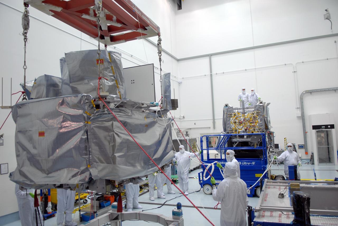 CAPE CANAVERAL, Fla. – At the Astrotech payload processing facility in Titusville, Fla., a crane moves the SV1 spacecraft, toward the SV2 at right.  The two spacecraft , which will be mated, are part of the Space Tracking and Surveillance System – Demonstrators, or STSS Demo, Program. The STSS Demo is a space-based sensor component of a layered Ballistic Missile Defense System designed for the overall mission of detecting, tracking and discriminating ballistic missiles.  STSS is capable of tracking objects after boost phase and provides trajectory information to other sensors. It will be launched by NASA for the Missile Defense Agency between 8 and 8:58 a.m. EDT Sept. 18.  Approved for Public Release 09-MDA-04886 (10 SEPT 09) Photo credit: NASA/Jim Grossmann