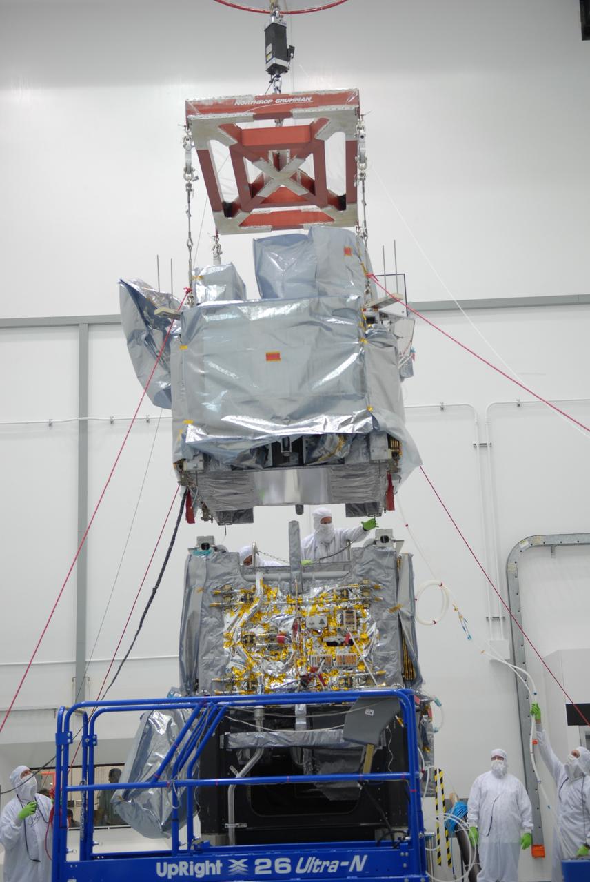 CAPE CANAVERAL, Fla. – At the Astrotech payload processing facility in Titusville, Fla., the SV1 spacecraft is lowered toward the SV2 for mating. The two spacecraft are part of the Space Tracking and Surveillance System – Demonstrators, or STSS Demo, Program.  The STSS Demo is a space-based sensor component of a layered Ballistic Missile Defense System designed for the overall mission of detecting, tracking and discriminating ballistic missiles.  STSS is capable of tracking objects after boost phase and provides trajectory information to other sensors. It will be launched by NASA for the Missile Defense Agency between 8 and 8:58 a.m. EDT Sept. 18.  Approved for Public Release 09-MDA-04886 (10 SEPT 09) Photo credit: NASA/Jim Grossmann