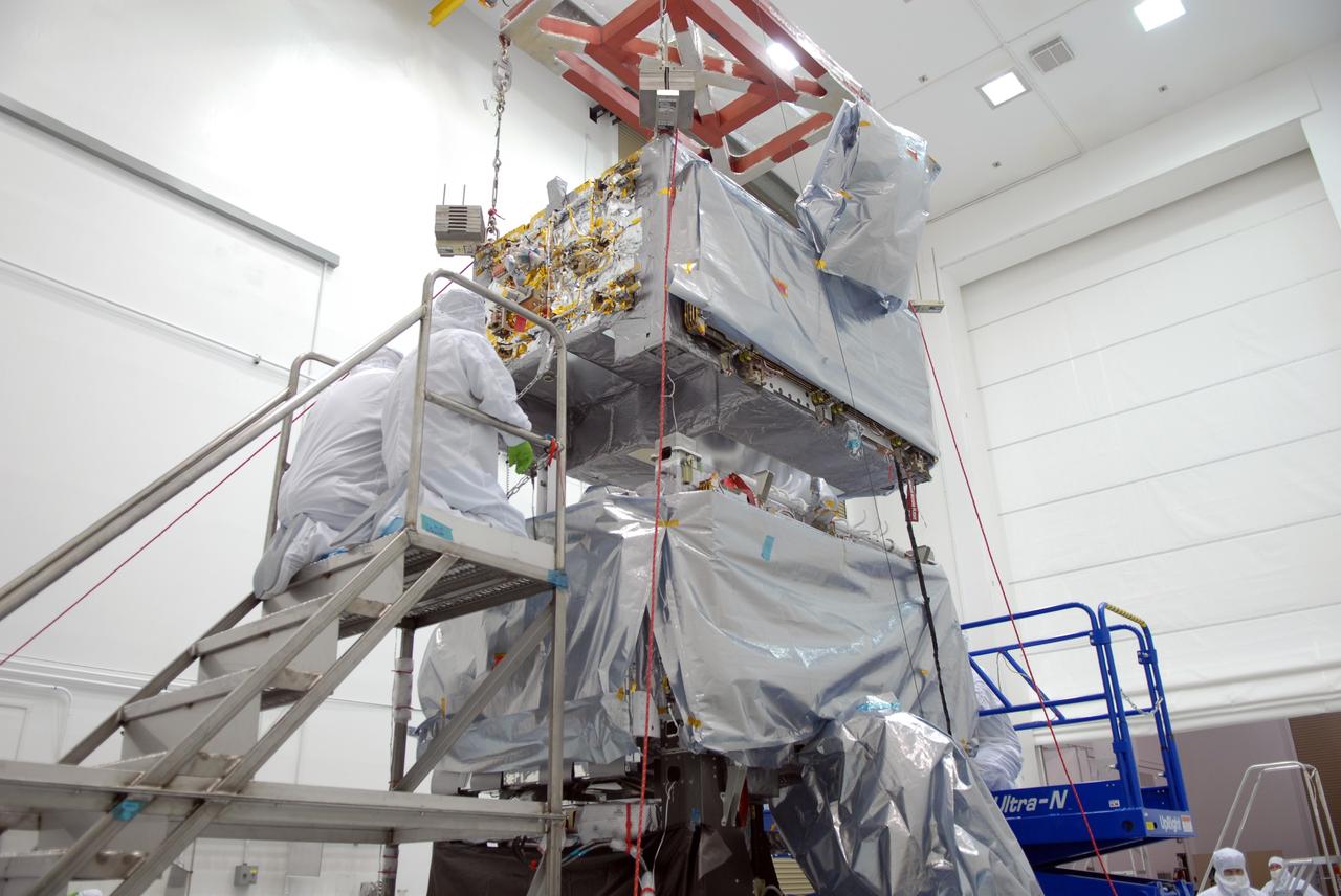 CAPE CANAVERAL, Fla. –At the Astrotech payload processing facility in Titusville, Fla., the SV1 spacecraft is lowered onto the SV2 for mating. The two spacecraft are part of the Space Tracking and Surveillance System – Demonstrators, or STSS Demo, Program.    The STSS Demo is a space-based sensor component of a layered Ballistic Missile Defense System designed for the overall mission of detecting, tracking and discriminating ballistic missiles.  STSS is capable of tracking objects after boost phase and provides trajectory information to other sensors. It will be launched by NASA for the Missile Defense Agency between 8 and 8:58 a.m. EDT Sept. 18.  Approved for Public Release 09-MDA-04886 (10 SEPT 09) Photo credit: NASA/Jim Grossmann