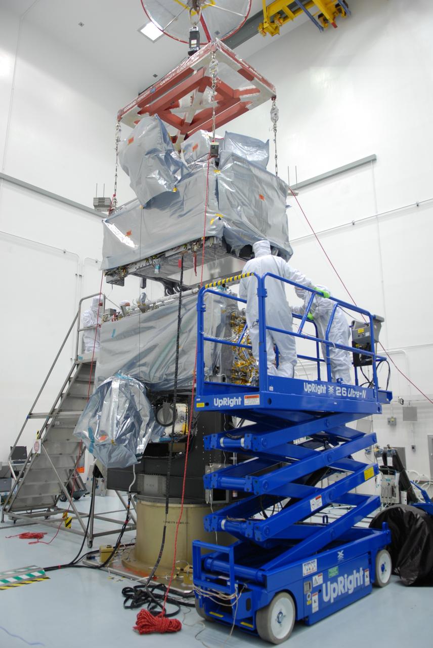 CAPE CANAVERAL, Fla. – At the Astrotech payload processing facility in Titusville, Fla., workers observe as the SV1 spacecraft is lowered onto the SV2 for mating. The two spacecraft are part of the Space Tracking and Surveillance System – Demonstrators, or STSS Demo, Program.   The STSS Demo is a space-based sensor component of a layered Ballistic Missile Defense System designed for the overall mission of detecting, tracking and discriminating ballistic missiles.  STSS is capable of tracking objects after boost phase and provides trajectory information to other sensors. It will be launched by NASA for the Missile Defense Agency between 8 and 8:58 a.m. EDT Sept. 18.  Approved for Public Release 09-MDA-04886 (10 SEPT 09) Photo credit: NASA/Jim Grossmann