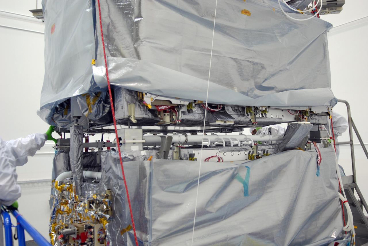 CAPE CANAVERAL, Fla. – At the Astrotech payload processing facility in Titusville, Fla., the SV1 spacecraft is lowered onto the SV2 for mating. The two spacecraft are part of the Space Tracking and Surveillance System – Demonstrators, or STSS Demo, Program.   The STSS Demo is a space-based sensor component of a layered Ballistic Missile Defense System designed for the overall mission of detecting, tracking and discriminating ballistic missiles.  STSS is capable of tracking objects after boost phase and provides trajectory information to other sensors. It will be launched by NASA for the Missile Defense Agency between 8 and 8:58 a.m. EDT Sept. 18.  Approved for Public Release 09-MDA-04886 (10 SEPT 09) Photo credit: NASA/Jim Grossmann