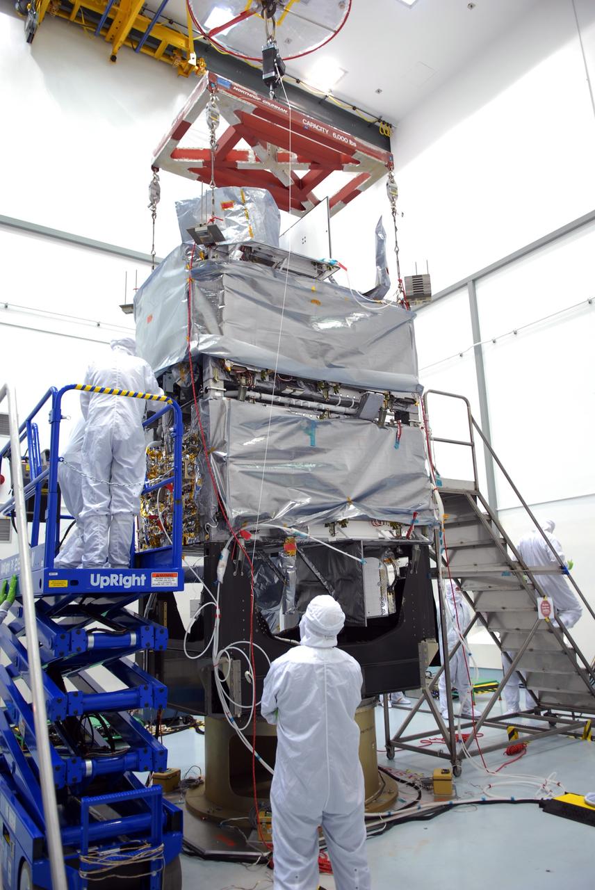 CAPE CANAVERAL, Fla. – At the Astrotech payload processing facility in Titusville, Fla., workers check the mating of the SV1 spacecraft onto the SV2. The two spacecraft are part of the Space Tracking and Surveillance System – Demonstrators, or STSS Demo, Program.  The STSS Demo is a space-based sensor component of a layered Ballistic Missile Defense System designed for the overall mission of detecting, tracking and discriminating ballistic missiles.  STSS is capable of tracking objects after boost phase and provides trajectory information to other sensors. It will be launched by NASA for the Missile Defense Agency between 8 and 8:58 a.m. EDT Sept. 18.  Approved for Public Release 09-MDA-04886 (10 SEPT 09) Photo credit: NASA/Jim Grossmann