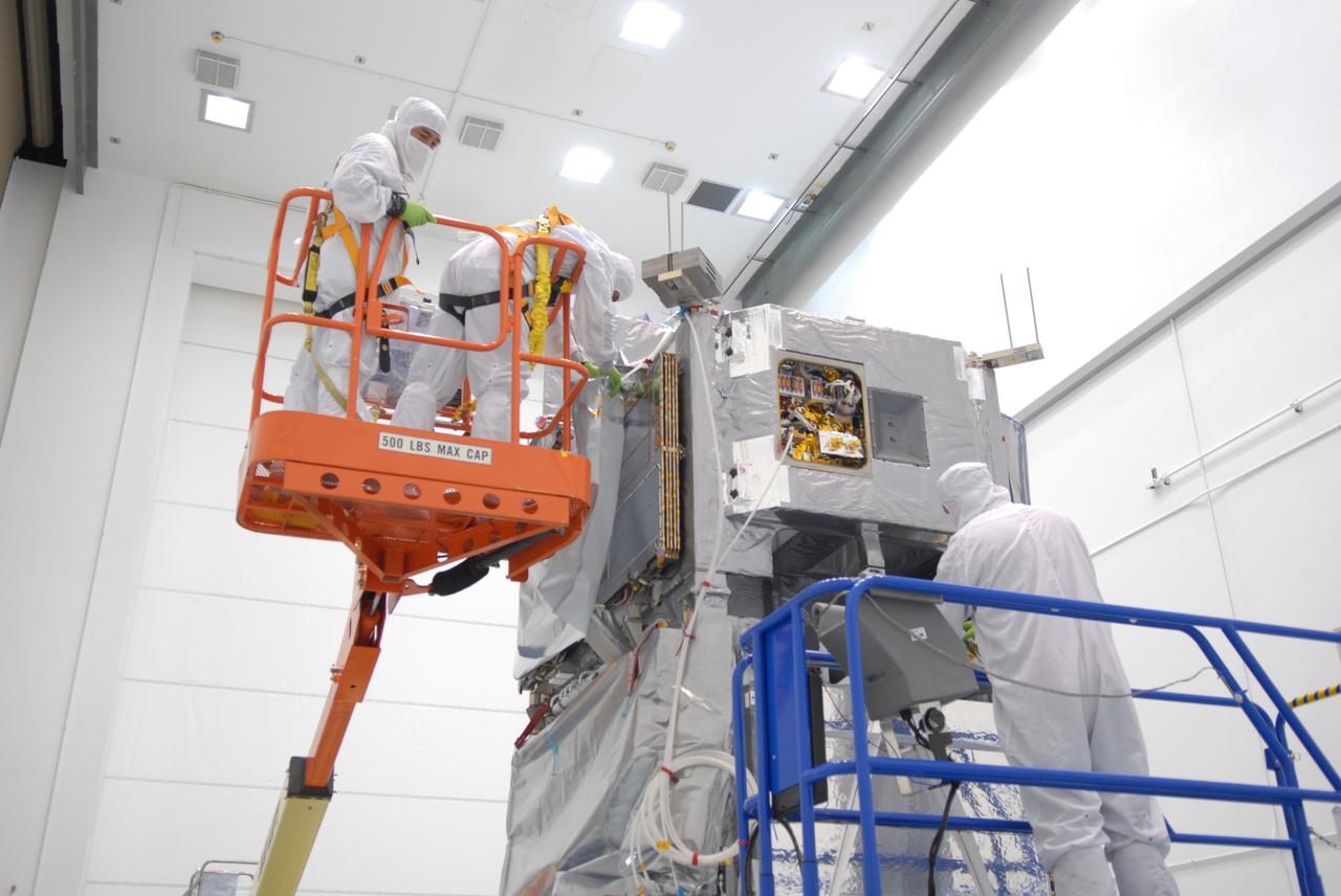 CAPE CANAVERAL, Fla. –  At the Astrotech payload processing facility in Titusville, Fla., workers remove covers around the mated SV1 and SV2 spacecraft before center of gravity testing, weighing and balancing.  The two spacecraft are known as the Space Tracking and Surveillance System – Demonstrators, or STSS Demo, which is a space-based sensor component of a layered Ballistic Missile Defense System designed for the overall mission of detecting, tracking and discriminating ballistic missiles.  STSS is capable of tracking objects after boost phase and provides trajectory information to other sensors. It will be launched by NASA for the Missile Defense Agency between 8 and 8:58 a.m. EDT Sept. 18.  Approved for Public Release 09-MDA-04886 (10 SEPT 09) Photo credit: NASA/Jim Grossmann