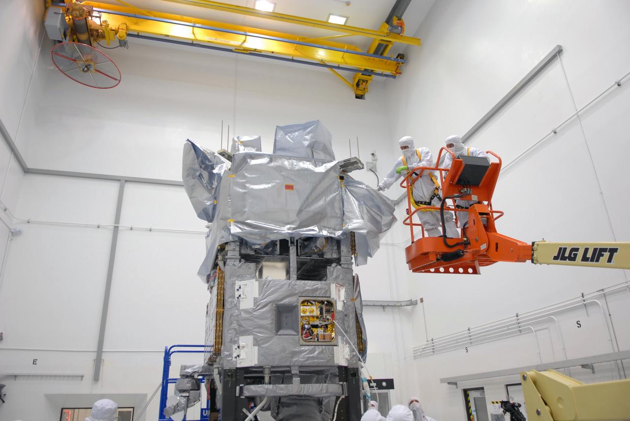 CAPE CANAVERAL, Fla. –  At the Astrotech payload processing facility in Titusville, Fla., workers remove covers around the mated SV1 and SV2 spacecraft before center of gravity testing, weighing and balancing. The two spacecraft are known as the Space Tracking and Surveillance System – Demonstrators, or STSS Demo, which is a space-based sensor component of a layered Ballistic Missile Defense System designed for the overall mission of detecting, tracking and discriminating ballistic missiles.  STSS is capable of tracking objects after boost phase and provides trajectory information to other sensors. It will be launched by NASA for the Missile Defense Agency between 8 and 8:58 a.m. EDT Sept. 18.  Approved for Public Release 09-MDA-04886 (10 SEPT 09) Photo credit: NASA/Jim Grossmann