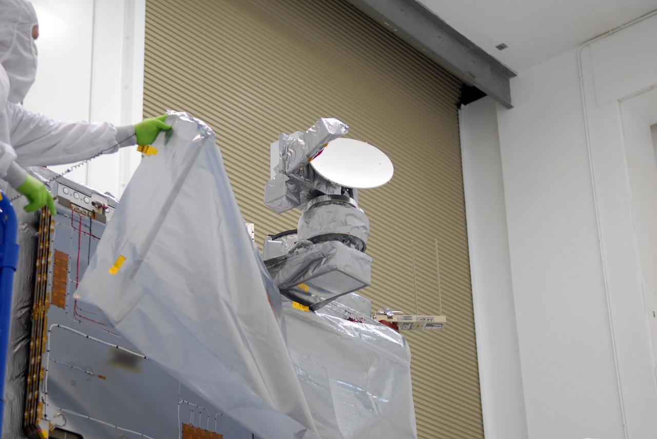 CAPE CANAVERAL, Fla. –  At the Astrotech payload processing facility in Titusville, Fla., workers remove covers around the mated SV1 and SV2 spacecraft before center of gravity testing, weighing and balancing. The two spacecraft are known as the Space Tracking and Surveillance System – Demonstrators, or STSS Demo, which is a space-based sensor component of a layered Ballistic Missile Defense System designed for the overall mission of detecting, tracking and discriminating ballistic missiles.  STSS is capable of tracking objects after boost phase and provides trajectory information to other sensors. It will be launched by NASA for the Missile Defense Agency between 8 and 8:58 a.m. EDT Sept. 18.  Approved for Public Release 09-MDA-04886 (10 SEPT 09) Photo credit: NASA/Jim Grossmann