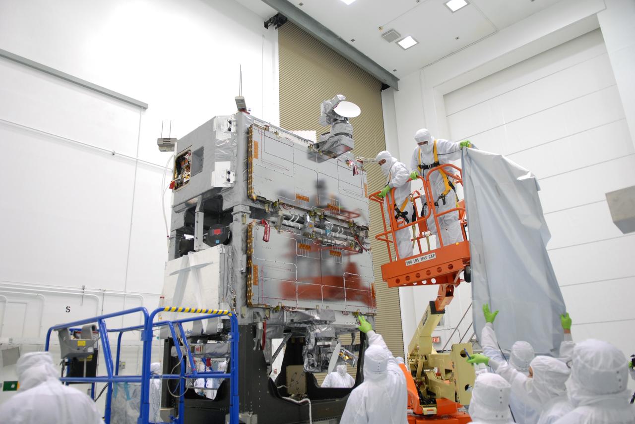 CAPE CANAVERAL, Fla. –  At the Astrotech payload processing facility in Titusville, Fla., workers remove a cover from around the mated SV1 and SV2 spacecraft before center of gravity testing, weighing and balancing. The two spacecraft are known as the Space Tracking and Surveillance System – Demonstrators, or STSS Demo, which is a space-based sensor component of a layered Ballistic Missile Defense System designed for the overall mission of detecting, tracking and discriminating ballistic missiles.  STSS is capable of tracking objects after boost phase and provides trajectory information to other sensors. It will be launched by NASA for the Missile Defense Agency between 8 and 8:58 a.m. EDT Sept. 18.  Approved for Public Release 09-MDA-04886 (10 SEPT 09) Photo credit: NASA/Jim Grossmann