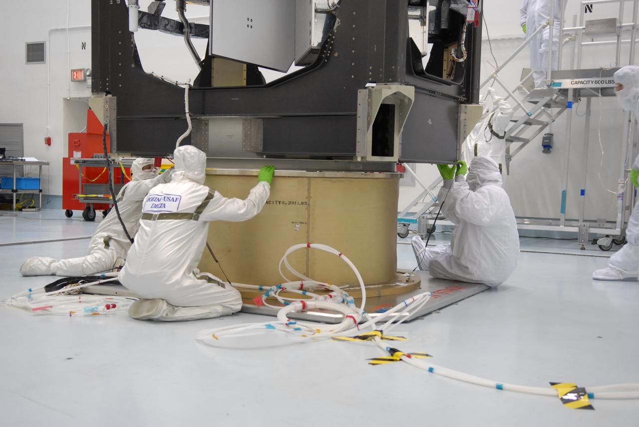 CAPE CANAVERAL, Fla. – At the Astrotech payload processing facility in Titusville, Fla., workers observe as the SV1-SV2 spacecraft is lifted for weighing.  The two spacecraft are known as the Space Tracking and Surveillance System – Demonstrators, or STSS Demo, which is a space-based sensor component of a layered Ballistic Missile Defense System designed for the overall mission of detecting, tracking and discriminating ballistic missiles.  STSS is capable of tracking objects after boost phase and provides trajectory information to other sensors. It will be launched by NASA for the Missile Defense Agency between 8 and 8:58 a.m. EDT Sept. 18.  Approved for Public Release 09-MDA-04886 (10 SEPT 09) Photo credit: NASA/Jim Grossmann