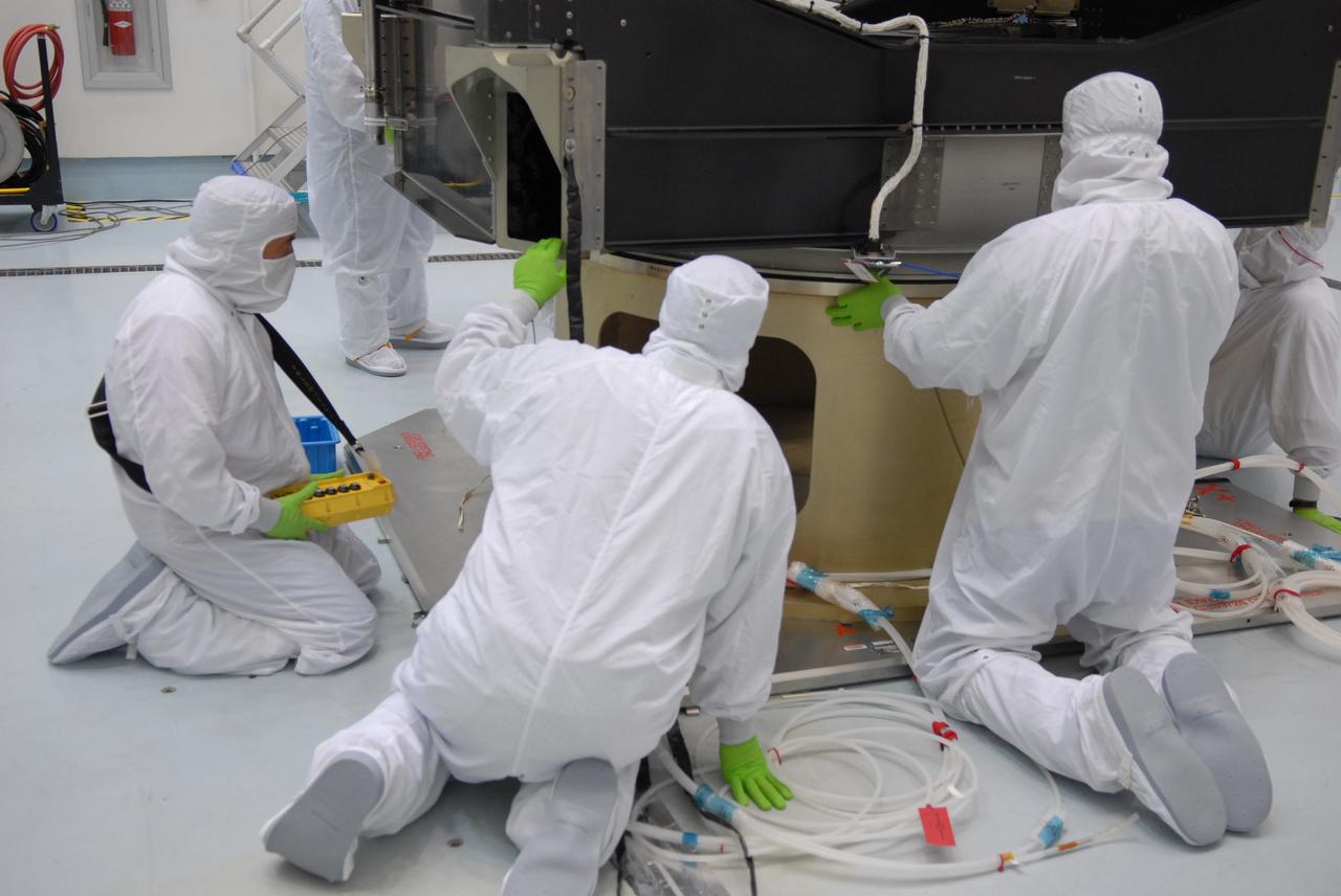 CAPE CANAVERAL, Fla. – At the Astrotech payload processing facility in Titusville, Fla., workers observe as the SV1-SV2 spacecraft is lowered again onto the rotation stand after weighing. The two spacecraft are known as the Space Tracking and Surveillance System – Demonstrators, or STSS Demo, which is a space-based sensor component of a layered Ballistic Missile Defense System designed for the overall mission of detecting, tracking and discriminating ballistic missiles.  STSS is capable of tracking objects after boost phase and provides trajectory information to other sensors. It will be launched by NASA for the Missile Defense Agency between 8 and 8:58 a.m. EDT Sept. 18.  Approved for Public Release 09-MDA-04886 (10 SEPT 09) Photo credit: NASA/Jim Grossmann