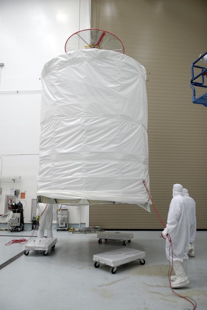 CAPE CANAVERAL, Fla. – At the Astrotech payload processing facility in Titusville, Fla., the upper segment of the transportation canister is lifted to be placed on the top of the Space Tracking and Surveillance System – Demonstrators, or STSS Demo, spacecraft.   The STSS Demo is a space-based sensor component of a layered Ballistic Missile Defense System designed for the overall mission of detecting, tracking and discriminating ballistic missiles.  STSS is capable of tracking objects after boost phase and provides trajectory information to other sensors. It will be launched by NASA for the Missile Defense Agency between 8 and 8:58 a.m. EDT Sept. 18.  Approved for Public Release 09-MDA-04886 (10 SEPT 09) Photo credit: NASA/Kim Shiflett