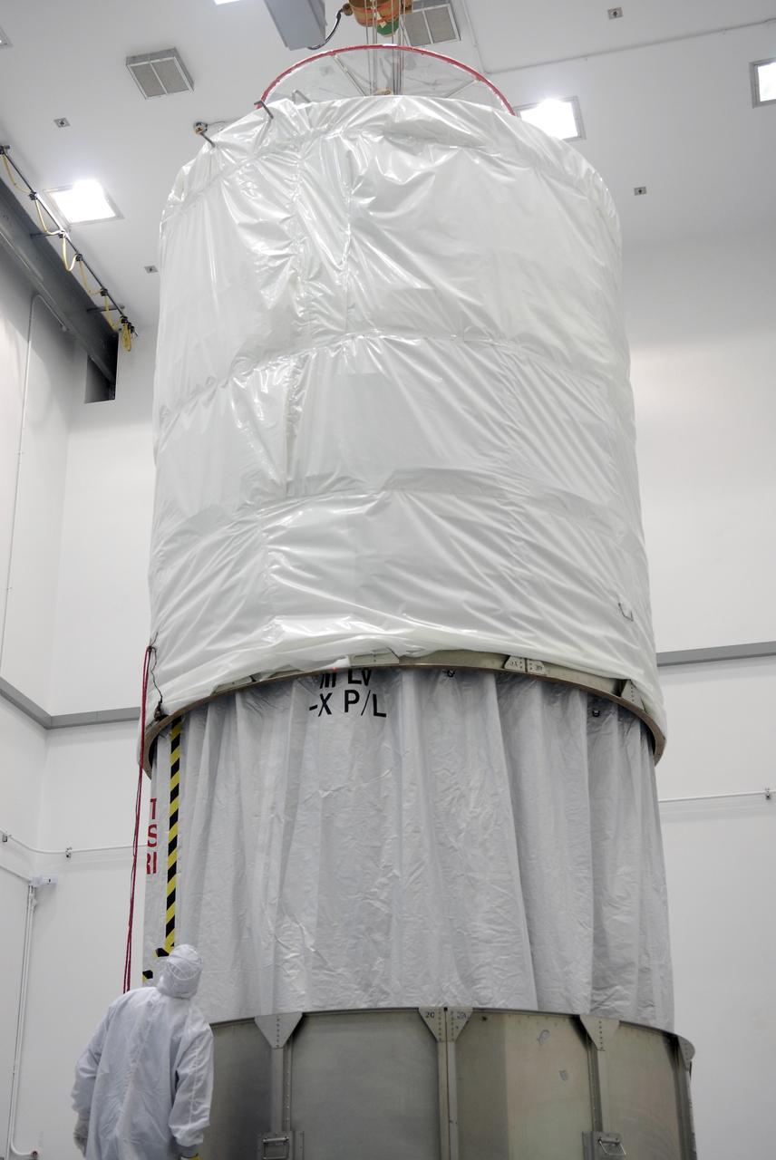 CAPE CANAVERAL, Fla. – At the Astrotech payload processing facility in Titusville, Fla., the upper segment of the transportation canister is lowered over the Space Tracking and Surveillance System – Demonstrators, or STSS Demo, spacecraft.  It will be installed onto the lower segments already in place.  The STSS Demo is a space-based sensor component of a layered Ballistic Missile Defense System designed for the overall mission of detecting, tracking and discriminating ballistic missiles.  STSS is capable of tracking objects after boost phase and provides trajectory information to other sensors. It will be launched by NASA for the Missile Defense Agency between 8 and 8:58 a.m. EDT Sept. 18.  Approved for Public Release 09-MDA-04886 (10 SEPT 09) Photo credit: NASA/Kim Shiflett