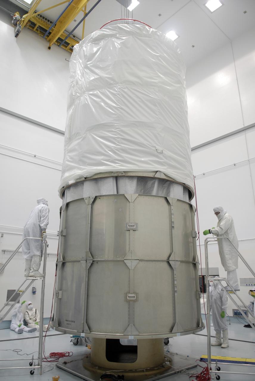 CAPE CANAVERAL, Fla. – At the Astrotech payload processing facility in Titusville, Fla., the upper segment of the transportation canister is lowered over the Space Tracking and Surveillance System – Demonstrators, or STSS Demo, spacecraft.  It will be installed onto the lower segments already in place.  The STSS Demo is a space-based sensor component of a layered Ballistic Missile Defense System designed for the overall mission of detecting, tracking and discriminating ballistic missiles.  STSS is capable of tracking objects after boost phase and provides trajectory information to other sensors. It will be launched by NASA for the Missile Defense Agency between 8 and 8:58 a.m. EDT Sept. 18.  Approved for Public Release 09-MDA-04886 (10 SEPT 09) Photo credit: NASA/Kim Shiflett