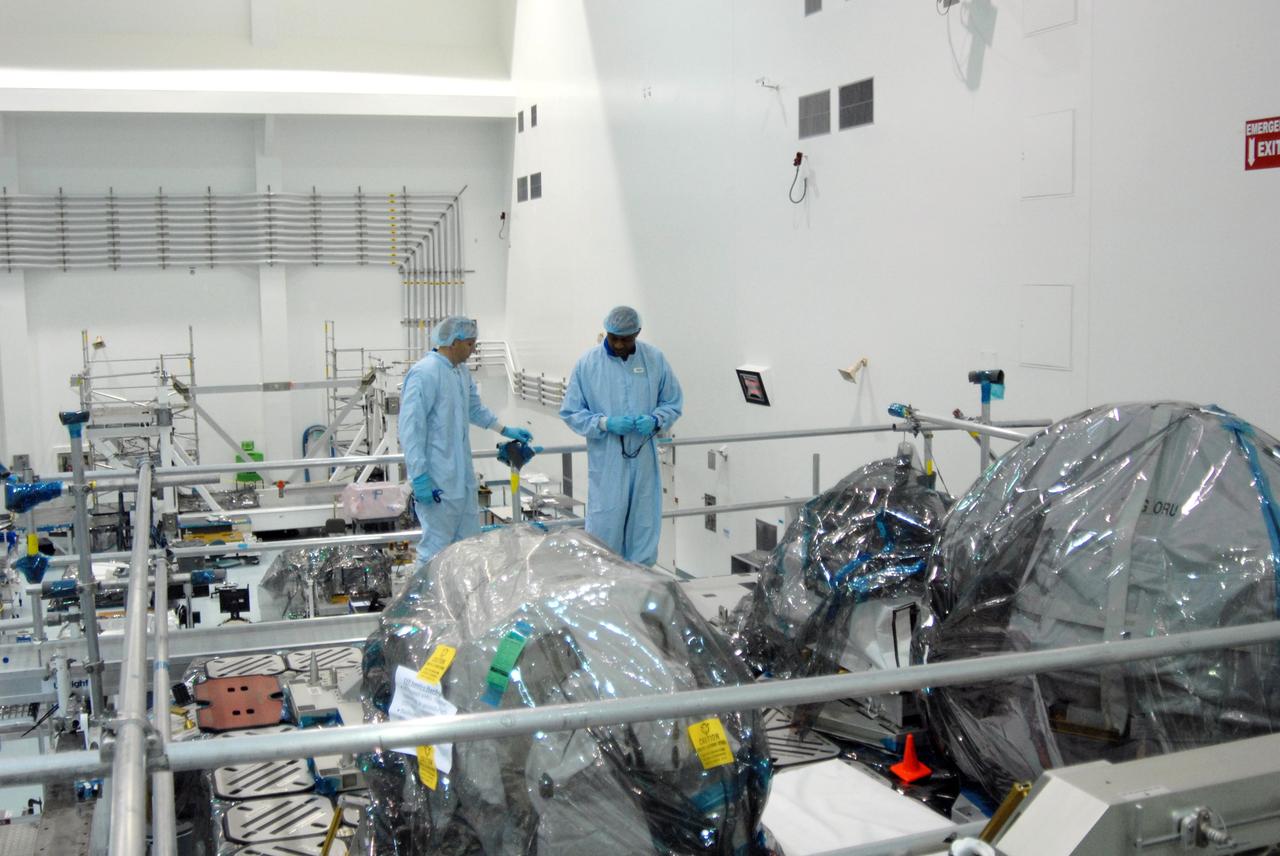 CAPE CANAVERAL, Fla. – Members of the STS-129 crew spend time in NASA Kennedy Space Center's Space Station Processing Facility looking over the payloads installed on the Express Logistics Carrier, or ELC.  The crew is at Kennedy for a Crew Equipment Interface Test, which provides hands-on training and observation of shuttle and flight hardware. The carrier is part of the STS-129 payload on space shuttle Atlantis, which will deliver to the International Space Station two spare gyroscopes, two nitrogen tank assemblies, two pump modules, an ammonia tank assembly and a spare latching end effector for the station's robotic arm. STS-129 is targeted to launch Nov. 12.   Photo credit: NASA/Jim Grossmann
