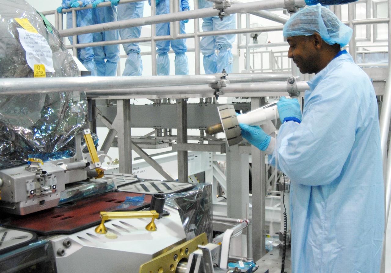 CAPE CANAVERAL, Fla. – In NASA Kennedy Space Center's Space Station Processing Facility, STS-129 Mission Specialist Robert Satcher becomes familiar with equipment installed on the Express Logistics Carrier, or ELC.  The crew is at Kennedy for a Crew Equipment Interface Test, which provides hands-on training and observation of shuttle and flight hardware. The carrier is part of the STS-129 payload on space shuttle Atlantis, which will deliver to the International Space Station two spare gyroscopes, two nitrogen tank assemblies, two pump modules, an ammonia tank assembly and a spare latching end effector for the station's robotic arm. STS-129 is targeted to launch Nov. 12.   Photo credit: NASA/Jim Grossmann