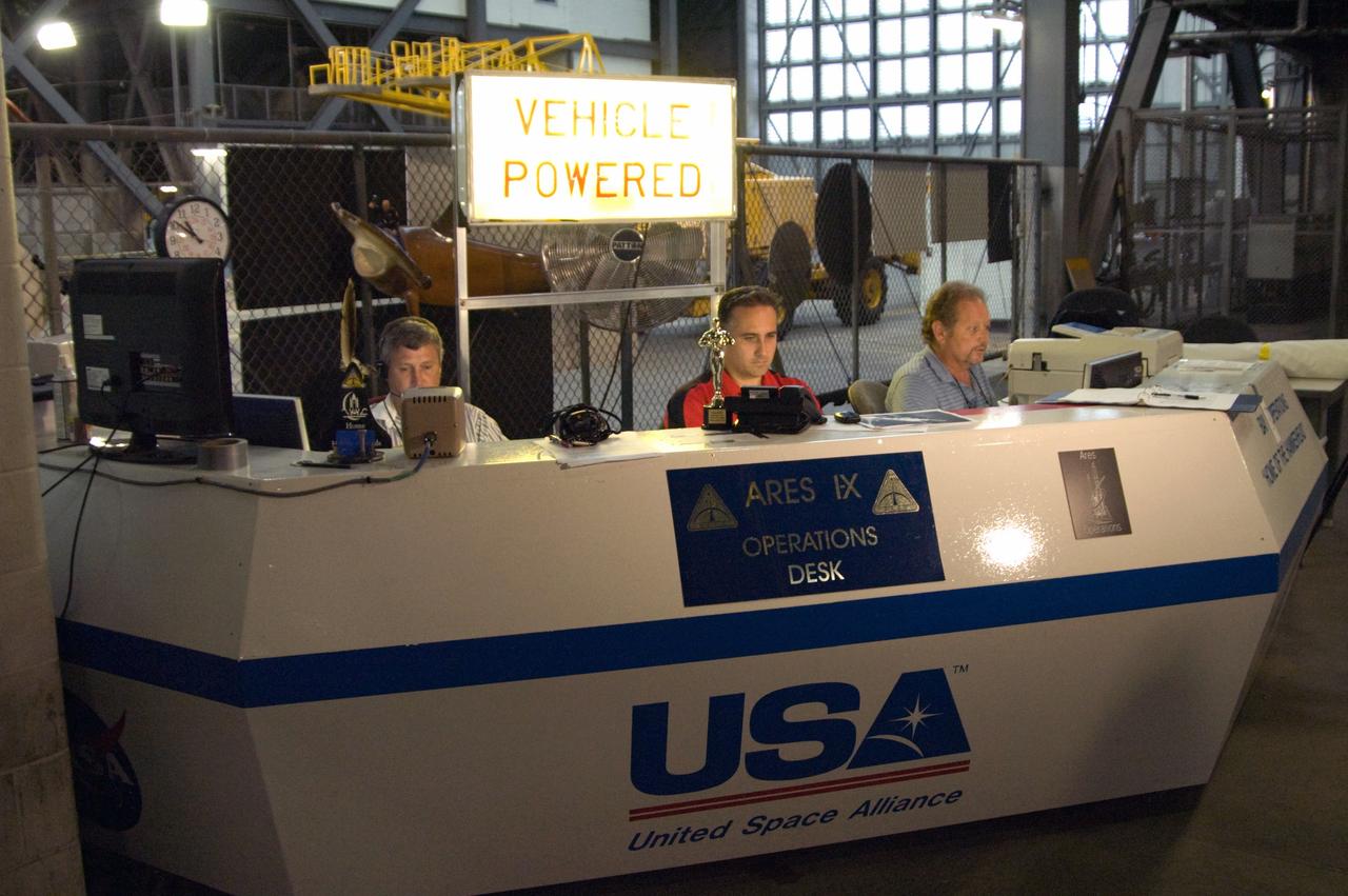 CAPE CANAVERAL, Fla. – In NASA Kennedy Space Center's Vehicle Assembly Building High Bay 3, NASA's Ares I-X mission team members Bobby Williams, Trent Smith and Karl Kendall monitor the rocket's first power-up. Part of the Constellation Program, the Ares I-X is the test vehicle for the Ares I, which is the essential core of a space transportation system that eventually will carry crewed missions back to the moon, on to Mars and out into the solar system. The Ares I-X flight test is targeted for  Oct. 31.  Photo credit: NASA/Cory Huston
