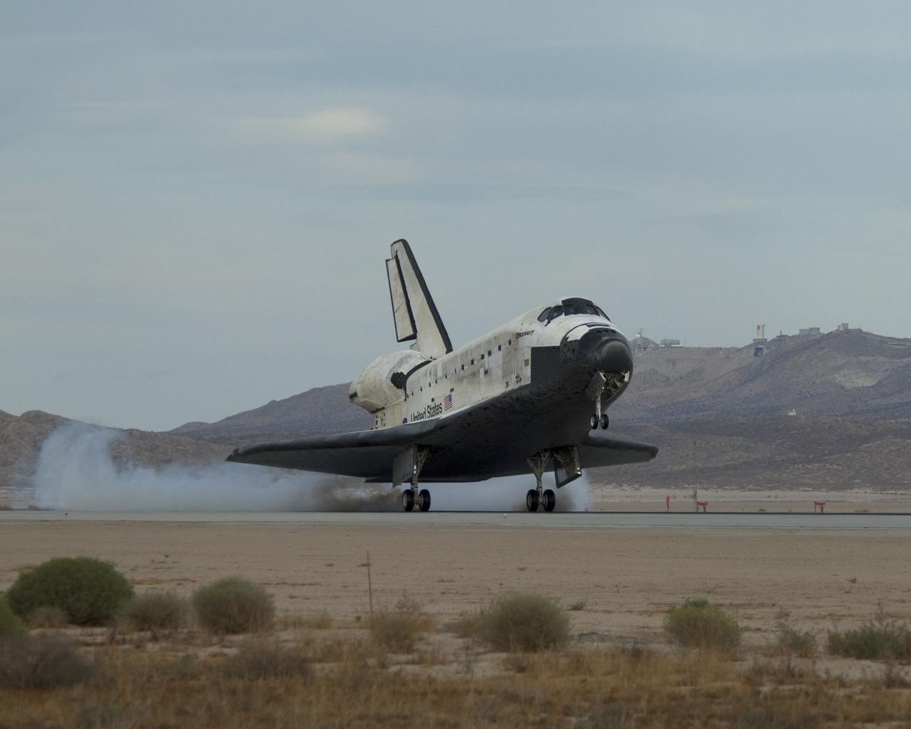 EDWARDS AIR FORCE BASE, Calif. -- (ED09-0253-01) Streams of smoke trail from the main landing gear tires as Space Shuttle Discovery touches down on Runway 22L at Edwards Air Force Base to conclude the almost 14-day STS-128 mission to the International Space Station. (NASA photo / Jim Ross)