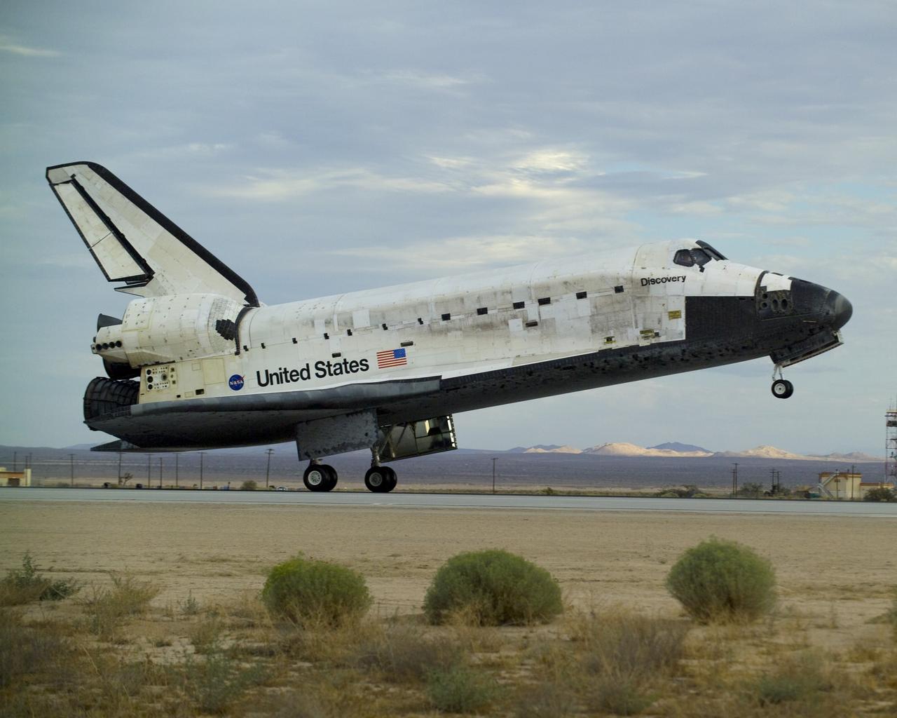 EDWARDS AIR FORCE BASE, Calif. -- (ED09-0253-03) Its nose still high in the air, Space Shuttle Discovery rolls down Runway 22L at Edwards Air Force Base shortly before sunset on Sept. 11, 2009 and the end of mission STS-128. (NASA photo / David Huskey/WSTF)