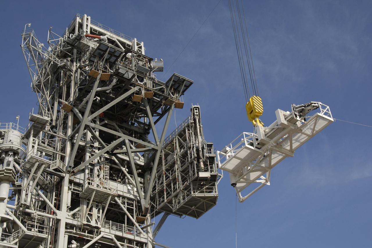CAPE CANAVERAL, Fla. –  On NASA Kennedy Space Center's Launch Pad 39B, the stabilizing arm is lifted toward the fixed service structure where it will be attached.  The arm will be used in the Ares I-X rocket launch, targeted for Oct. 31.  Ares I-X is part of NASA's Constellation Program.  Photo credit: NASA/Kim Shiflett
