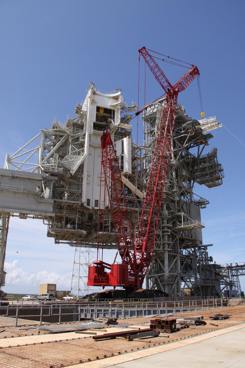 CAPE CANAVERAL, Fla. –  On NASA Kennedy Space Center's Launch Pad 39B, a second stabilizing arm  is moved into place (at upper right) on the top of the fixed service structure for installation. The hardware is being reconfigured for launch of NASA's Ares I-X rocket, part of the agency's Constellation Program.  The Ares I-X flight test is targeted for Oct. 31.  Photo credit: NASA/Troy Cryder