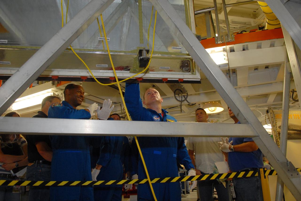 CAPE CANAVERAL, Fla. – In NASA Kennedy Space Center's Orbiter Processing Facility 1, STS-129 crew members look over equipment that is part of the mission.  In the foreground are Mission Specialist Robert Satcher and Pilot Barry Wilmore. The crew is at Kennedy for a Crew Equipment Interface Test, which provides hands-on training and observation of shuttle and flight hardware.  Space shuttle Atlantis' STS-129 mission is targeted to launch Nov. 12.  Photo credit: NASA/Jim Grossmann