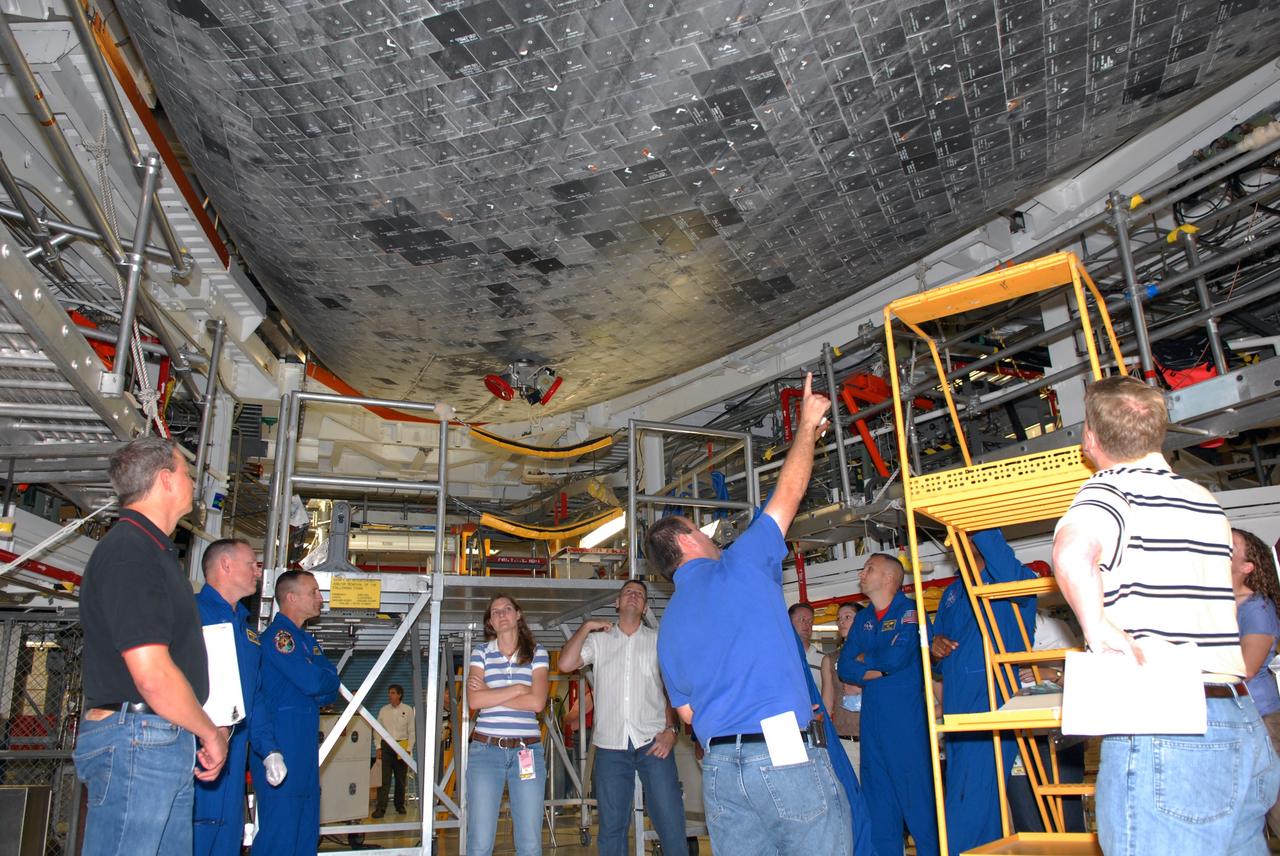 CAPE CANAVERAL, Fla. – In NASA Kennedy Space Center's Orbiter Processing Facility 1, STS-129 crew members get a close look at the tiles on the underside of space shuttle Atlantis.  At left are Pilot Barry Wilmore and Commander Charles Hobaugh.  At right are Mission Specialists Randy Bresnik and Robert Satcher.  The crew is at Kennedy for a Crew Equipment Interface Test, which provides hands-on training and observation of shuttle and flight hardware.  Atlantis' STS-129 mission is targeted to launch Nov. 12.  Photo credit: NASA/Jim Grossmann
