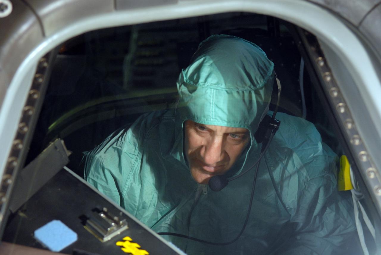CAPE CANAVERAL, Fla. – In NASA Kennedy Space Center's Orbiter Processing Facility 1, STS-129 Commander Charles Hobaugh checks the cockpit window in space shuttle Atlantis.  The crew is at Kennedy for a Crew Equipment Interface Test, which provides hands-on training and observation of shuttle and flight hardware.  Atlantis' STS-129 mission is targeted to launch Nov. 12.  Photo credit: NASA/Jim Grossmann