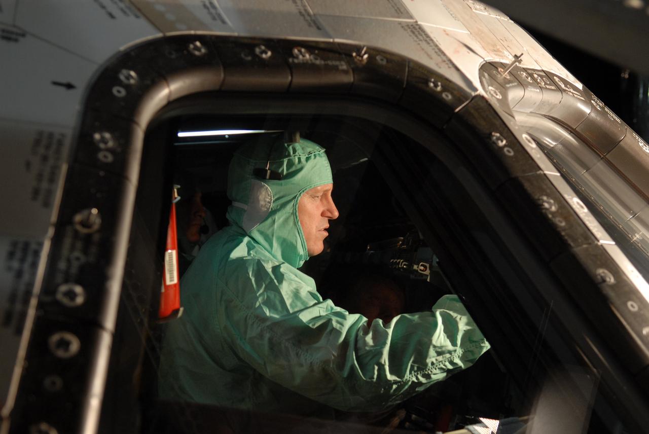 CAPE CANAVERAL, Fla. – In NASA Kennedy Space Center's Orbiter Processing Facility 1, STS-129 Pilot Barry Wilmore checks the cockpit window in space shuttle Atlantis.  The crew is at Kennedy for a Crew Equipment Interface Test, which provides hands-on training and observation of shuttle and flight hardware.  Atlantis' STS-129 mission is targeted to launch Nov. 12.  Photo credit: NASA/Jim Grossmann