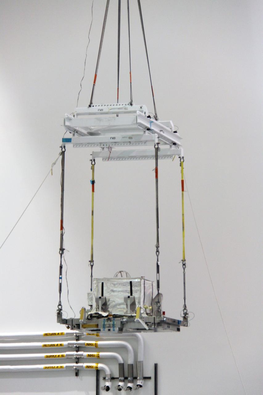 CAPE CANAVERAL, Fla. – In the Space Station Processing Facility at NASA's Kennedy Space Center in Florida,  a crane lifts the plasma contactor unit, or PCU, that will be installed on the Express Logistics Carrier, or ELC.  The PCU is used to disperse electrical charge build-ups on the International Space Station. The carrier is part of the STS-129 payload on space shuttle Atlantis, which will deliver to the International Space Station two spare gyroscopes, two nitrogen tank assemblies, two pump modules, an ammonia tank assembly and a spare latching end effector for the station's robotic arm. STS-129 is targeted to launch Nov. 12.  Photo credit: NASA/Jack Pfaller