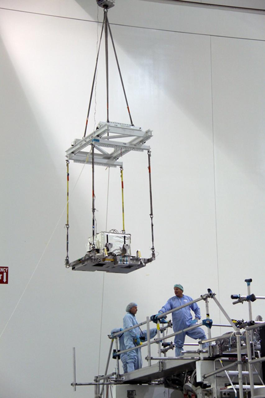 CAPE CANAVERAL, Fla. – In the Space Station Processing Facility at NASA's Kennedy Space Center in Florida, a crane moves the plasma contactor unit, or PCU, that will be installed on the Express Logistics Carrier, or ELC. The PCU is used to disperse electrical charge build-ups on the International Space Station. The carrier is part of the STS-129 payload on space shuttle Atlantis, which will deliver to the International Space Station two spare gyroscopes, two nitrogen tank assemblies, two pump modules, an ammonia tank assembly and a spare latching end effector for the station's robotic arm. STS-129 is targeted to launch Nov. 12. Photo credit: NASA/Jack Pfaller