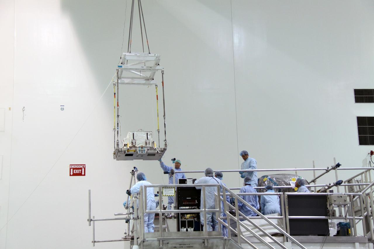 CAPE CANAVERAL, Fla. – In the Space Station Processing Facility at NASA's Kennedy Space Center in Florida,  a crane moves the plasma contactor unit, or PCU, that will be installed on the Express Logistics Carrier, or ELC.  The PCU is used to disperse electrical charge build-ups on the International Space Station. The carrier is part of the STS-129 payload on space shuttle Atlantis, which will deliver to the International Space Station two spare gyroscopes, two nitrogen tank assemblies, two pump modules, an ammonia tank assembly and a spare latching end effector for the station's robotic arm. STS-129 is targeted to launch Nov. 12.  Photo credit: NASA/Jack Pfaller