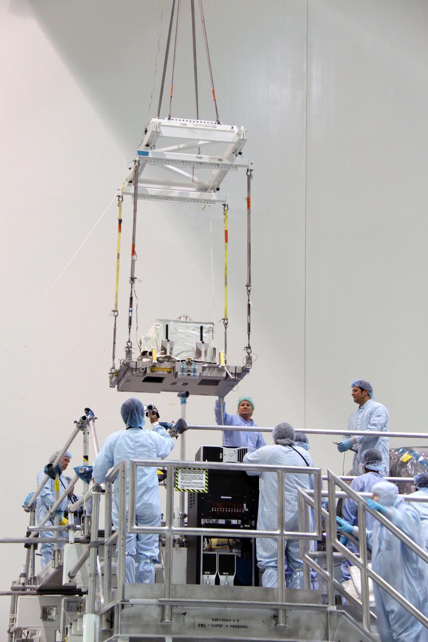 CAPE CANAVERAL, Fla. – In the Space Station Processing Facility at NASA's Kennedy Space Center in Florida, a crane lowers the plasma contactor unit, or PCU, that will be installed on the Express Logistics Carrier, or ELC. The PCU is used to disperse electrical charge build-ups on the International Space Station. The carrier is part of the STS-129 payload on space shuttle Atlantis, which will deliver to the International Space Station two spare gyroscopes, two nitrogen tank assemblies, two pump modules, an ammonia tank assembly and a spare latching end effector for the station's robotic arm. STS-129 is targeted to launch Nov. 12. Photo credit: NASA/Jack Pfaller