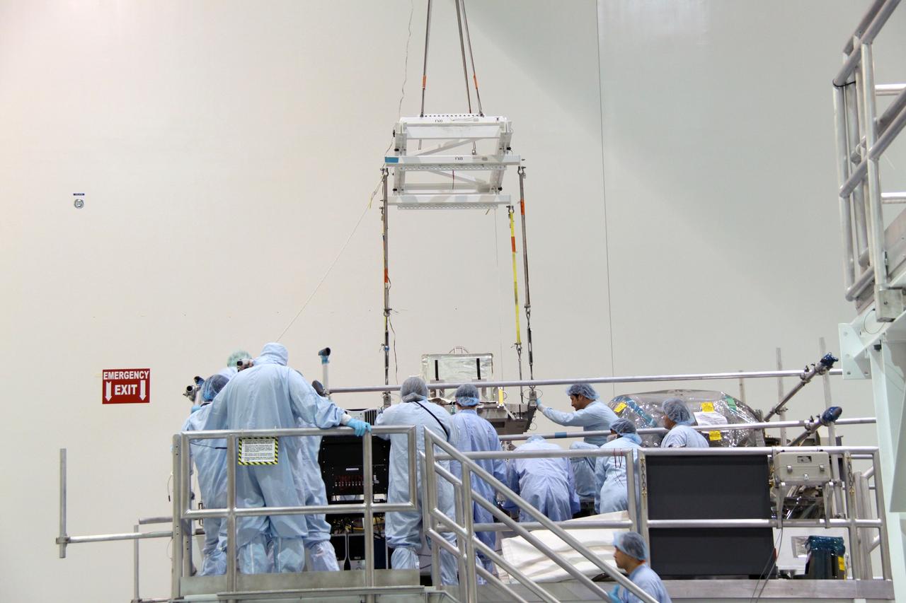 CAPE CANAVERAL, Fla. – In the Space Station Processing Facility at NASA's Kennedy Space Center in Florida,  a crane lowers the plasma contactor unit, or PCU, that will be installed on the Express Logistics Carrier, or ELC.  The PCU is used to disperse electrical charge build-ups on the International Space Station.  The carrier is part of the STS-129 payload on space shuttle Atlantis, which will deliver to the International Space Station two spare gyroscopes, two nitrogen tank assemblies, two pump modules, an ammonia tank assembly and a spare latching end effector for the station's robotic arm. STS-129 is targeted to launch Nov. 12.  Photo credit: NASA/Jack Pfaller