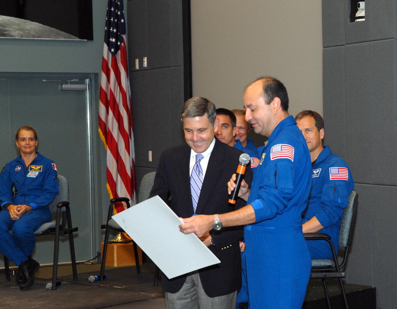 CAPE CANAVERAL, Fla. – Following a presentation by the STS-127 crew members about their experiences on the mission, Commander Mark Polansky (right) presents a plaque commemorating the mission to Kennedy Space Center Director Bob Cabana.  At far left is Mission Specialist Julie Payette.  Behind Cabana are Mission Specialist Christopher Cassidy and Pilot Doug Hurley.  Behind Polansky is Mission Specialist Tom Marshburn.  The STS-127 mission was the final of three flights dedicated to the assembly of the Japanese Kibo laboratory complex on the International Space Station.  The crew launched on space shuttle Endeavour on July 15 and returned July 31.  Photo credit: NASA/Jim Grossmann