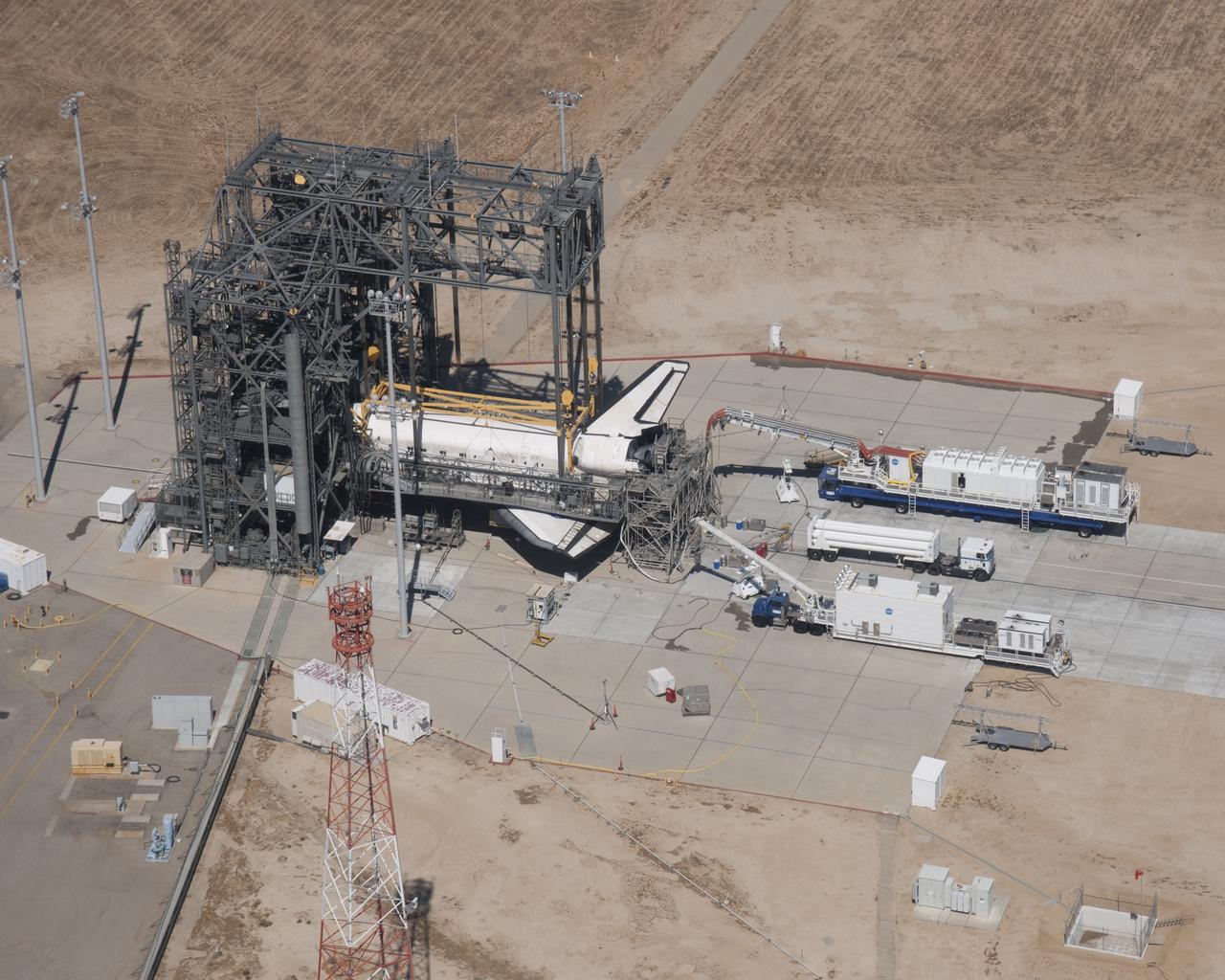 EDWARDS AIR FORCE BASE, Calif. – (ED09-0253-81) Space Shuttle Discovery is surrounded by the Mate-DeMate Device gantry and ground support equipment at NASA’s Dryden Flight Research Center during processing for its ferry flight back to the Kennedy Space Center in Florida.  Discovery returned to Earth Sept. 11 on the STS-128 mission, landing at Edwards Air Force Base in California.  The shuttle delivered more than 7 tons of supplies, science racks and equipment, as well as additional environmental hardware to sustain six crew members on the International Space Station.  Photo credit: NASA/Carla Thomas