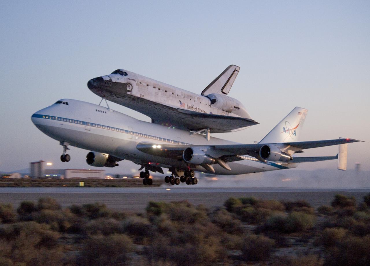 EDWARDS AIR FORCE BASE, Calif. – ED09-0253-103)  Space shuttle Discovery and its modified 747 carrier aircraft lift off from Edwards Air Force Base early in the morning on Sept. 20, 2009 on the first leg of its ferry flight back to the Kennedy Space Center in Florida. Discovery had landed at Edwards Sept. 11 after the STS-128 mission to the International Space Station. Discovery returned to Earth Sept. 11 on the STS-128 mission, landing at Edwards Air Force Base in California.  The shuttle delivered more than 7 tons of supplies, science racks and equipment, as well as additional environmental hardware to sustain six crew members on the International Space Station.  NASA photo /Tom Tschida