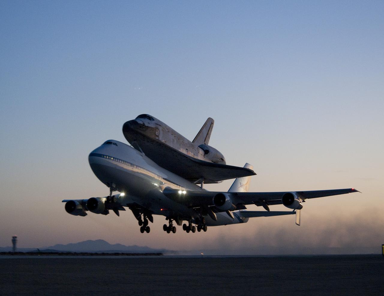 EDWARDS AIR FORCE BASE, Calif. – ED09-0253-108) Space shuttle Discovery and its modified 747 carrier aircraft lift off from Edwards Air Force Base early in the morning on Sept. 20, 2009 on the first leg of its ferry flight back to the Kennedy Space Center in Florida. Discovery had landed at Edwards Sept. 11 after the STS-128 mission to the International Space Station. The shuttle delivered more than 7 tons of supplies, science racks and equipment, as well as additional environmental hardware to sustain six crew members on the International Space Station. NASA photo /Tony Landis