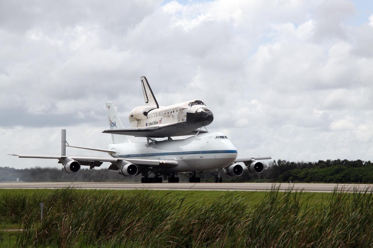 CAPE CANAVERAL, Fla. –  The Boeing 747 Shuttle Carrier Aircraft, or SCA, with space shuttle Discovery on top, touches down on runway 33 at NASA's Kennedy Space Center in Florida at 12:05 p.m. EDT.  The two-day return flight from Edwards Air Force Base in California began at 9:20 a.m. EDT Sept. 20.  After three fueling stops that included an overnight stay in Louisiana, the piggybacked shuttle had to navigate through a line of showers across Louisiana and around Kennedy. Discovery had landed at Edwards Sept. 11 after the 13-day STS-128 mission to the International Space Station. The shuttle delivered more than 7 tons of supplies, science racks and equipment, as well as additional environmental hardware to sustain six crew members on the station.  Landings at Kennedy were waved off on two days due to inclement weather, leading to the landing at Edwards.  Photo credit: NASA/Jack Pfaller
