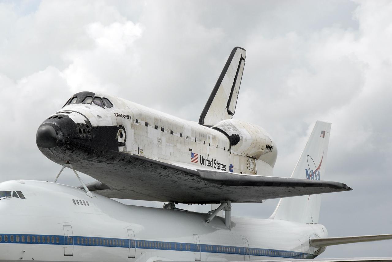 CAPE CANAVERAL, Fla. –  At NASA's Kennedy Space Center in Florida, space shuttle Discovery is attached to the Boeing 747 Shuttle Carrier Aircraft that ferried it from Edwards Air Force Base in California.  The piggybacked shuttle and aircraft landed on the Shuttle Landing Facility's runway 33 at 12:05 p.m. EDT.  The two-day return flight from Edwards Air Force Base in California began at 9:20 a.m. EDT Sept. 20.  After three fueling stops that included an overnight stay in Louisiana, the piggybacked shuttle had to navigate through a line of showers across Louisiana and around Kennedy. Discovery had landed at Edwards Sept. 11 after the 13-day STS-128 mission to the International Space Station. The shuttle delivered more than 7 tons of supplies, science racks and equipment, as well as additional environmental hardware to sustain six crew members on the station.  Landings at Kennedy were waved off on two days due to inclement weather, leading to the landing at Edwards.  Photo credit: NASA/Kim Shiflett