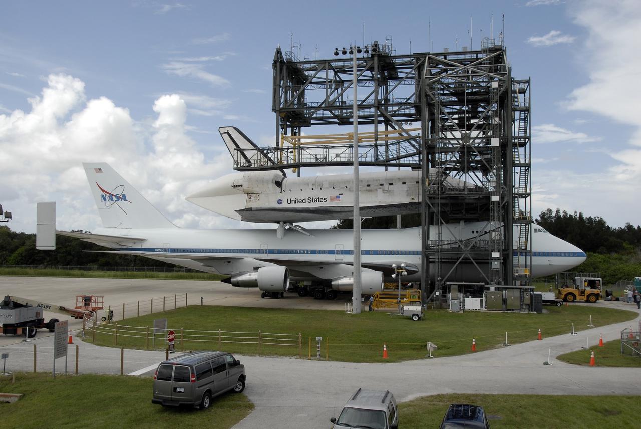 CAPE CANAVERAL, Fla. – At NASA Kennedy Space Center's Shuttle Landing Facility, platforms of the mate-demate device surround the 747 Shuttle Carrier Aircraft with space shuttle Discovery on top. The piggybacked shuttle and aircraft touched down on runway 33 at 12:05 p.m. EDT. Discovery landed at Edwards Air Force Base in California on Sept. 11 after the 13-day STS-128 mission to the International Space Station. Landings at Kennedy were waved off on two days due to inclement weather, leading to the landing at Edwards. The two-day return flight from California began at 9:20 a.m. EDT Sept. 20. Photo credit: NASA/Kim Shiflett