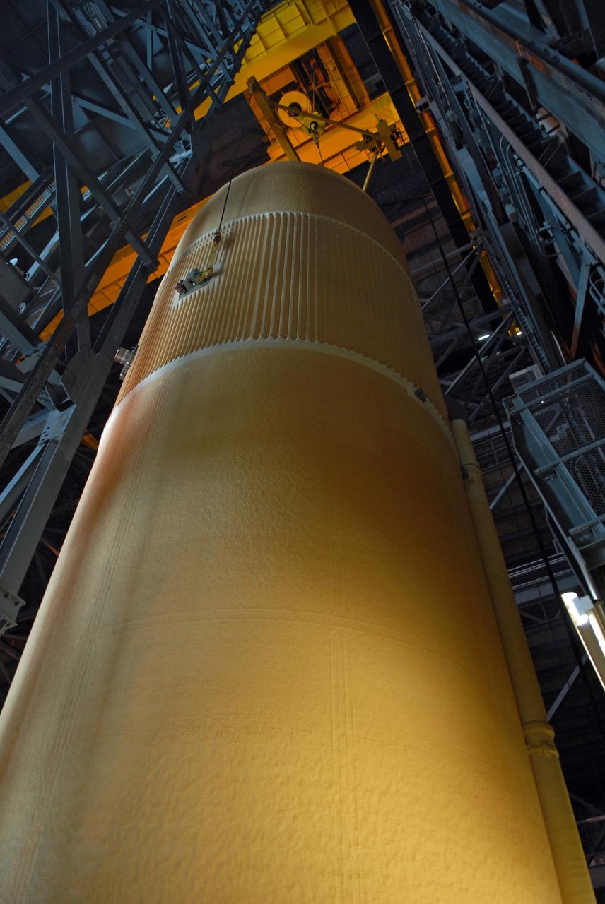 CAPE CANAVERAL, Fla. – The external fuel tank for space shuttle Atlantis' STS-129 mission is being lifted from the checkout cell of NASA Kennedy Space Center's Vehicle Assembly Building for transfer into high bay 2 and assembly with the solid rocket boosters already stacked on the mobile launch platform. The STS-129 mission is targeted to launch Nov. 12 on an 11-day supply mission to the International Space Station. Photo credit: NASA/Jim Grossmann