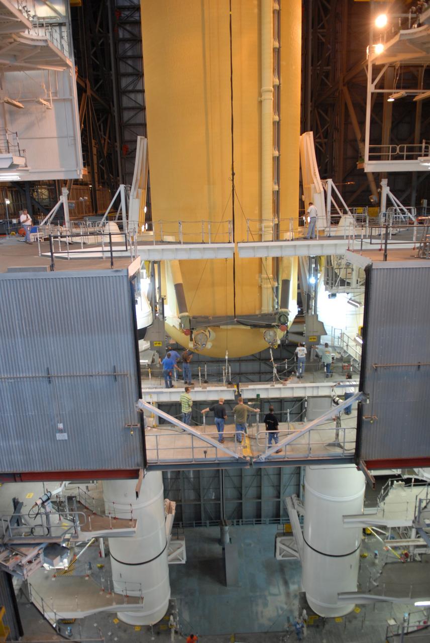 CAPE CANAVERAL, Fla. – The external fuel tank for space shuttle Atlantis' STS-129 mission is being lowered into NASA Kennedy Space Center's Vehicle Assembly Building high bay 2 for assembly with the solid rocket boosters already stacked on the mobile launch platform (seen at the bottom). The STS-129 mission is targeted to launch Nov. 12 on an 11-day supply mission to the International Space Station. Photo credit: NASA/Jim Grossmann