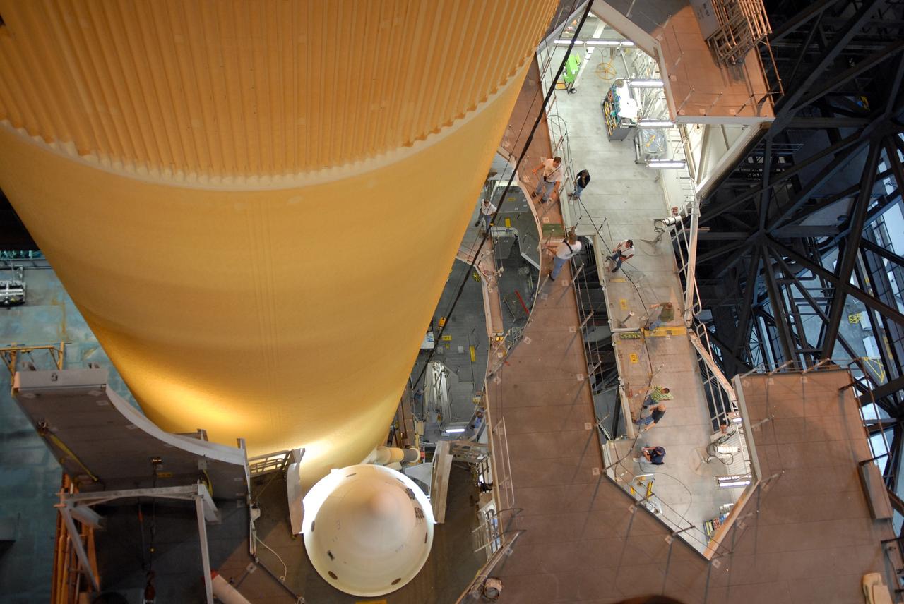 CAPE CANAVERAL, Fla. – The external fuel tank for space shuttle Atlantis' STS-129 mission is being lowered into NASA Kennedy Space Center's Vehicle Assembly Building high bay 2 for assembly with the solid rocket boosters already stacked on the mobile launch platform. The tip of one rocket is seen at bottom. The STS-129 mission is targeted to launch Nov. 12 on an 11-day supply mission to the International Space Station. Photo credit: NASA/Jim Grossmann