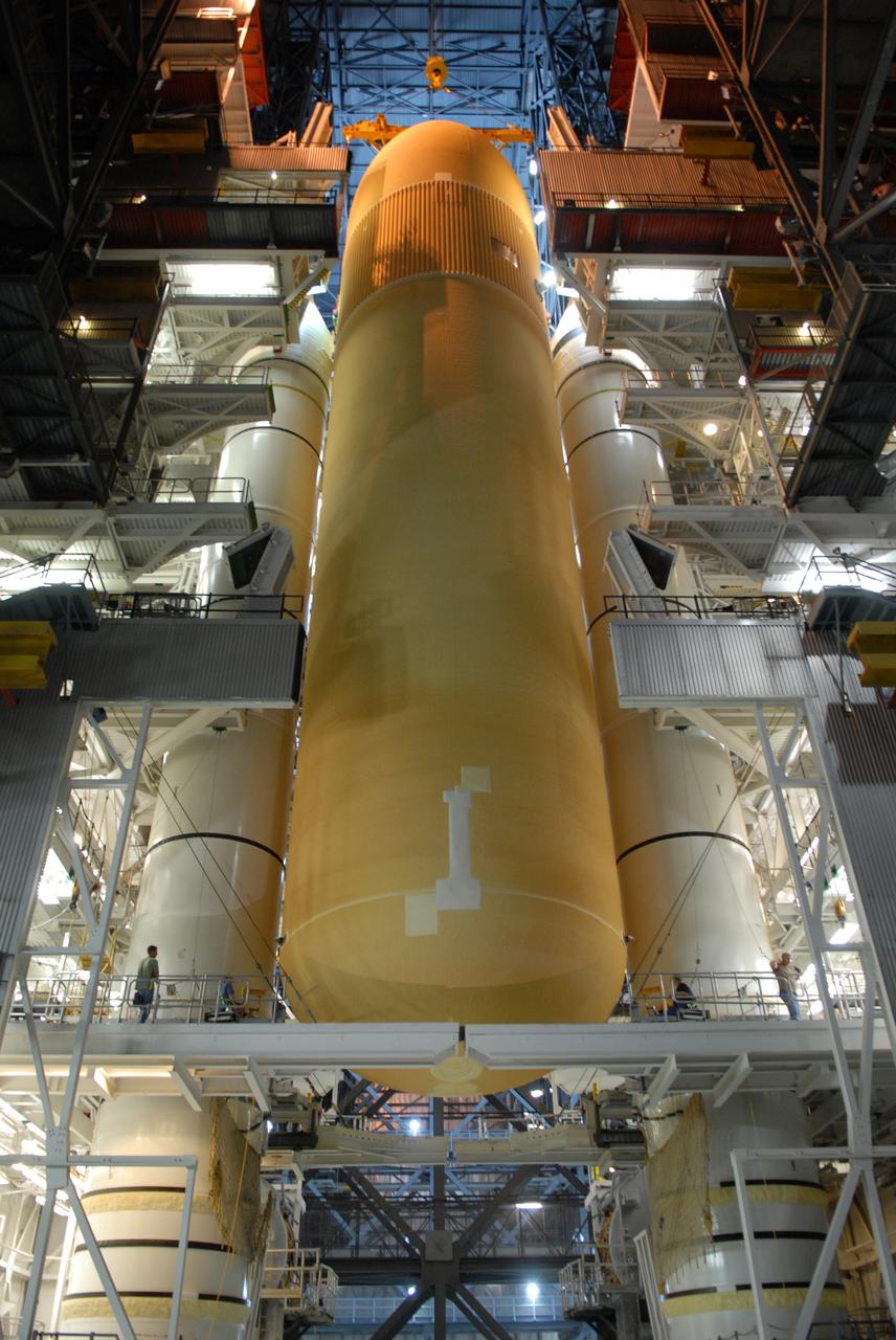 CAPE CANAVERAL, Fla. – The external fuel tank for space shuttle Atlantis' STS-129 mission is lowered between the solid rocket boosters stacked on the mobile launch platform in high bay 2 of NASA's Kennedy Space Center in Florida. The STS-129 mission is targeted to launch Nov. 12 on an 11-day supply mission to the International Space Station. Photo credit: NASA/Jim Grossmann