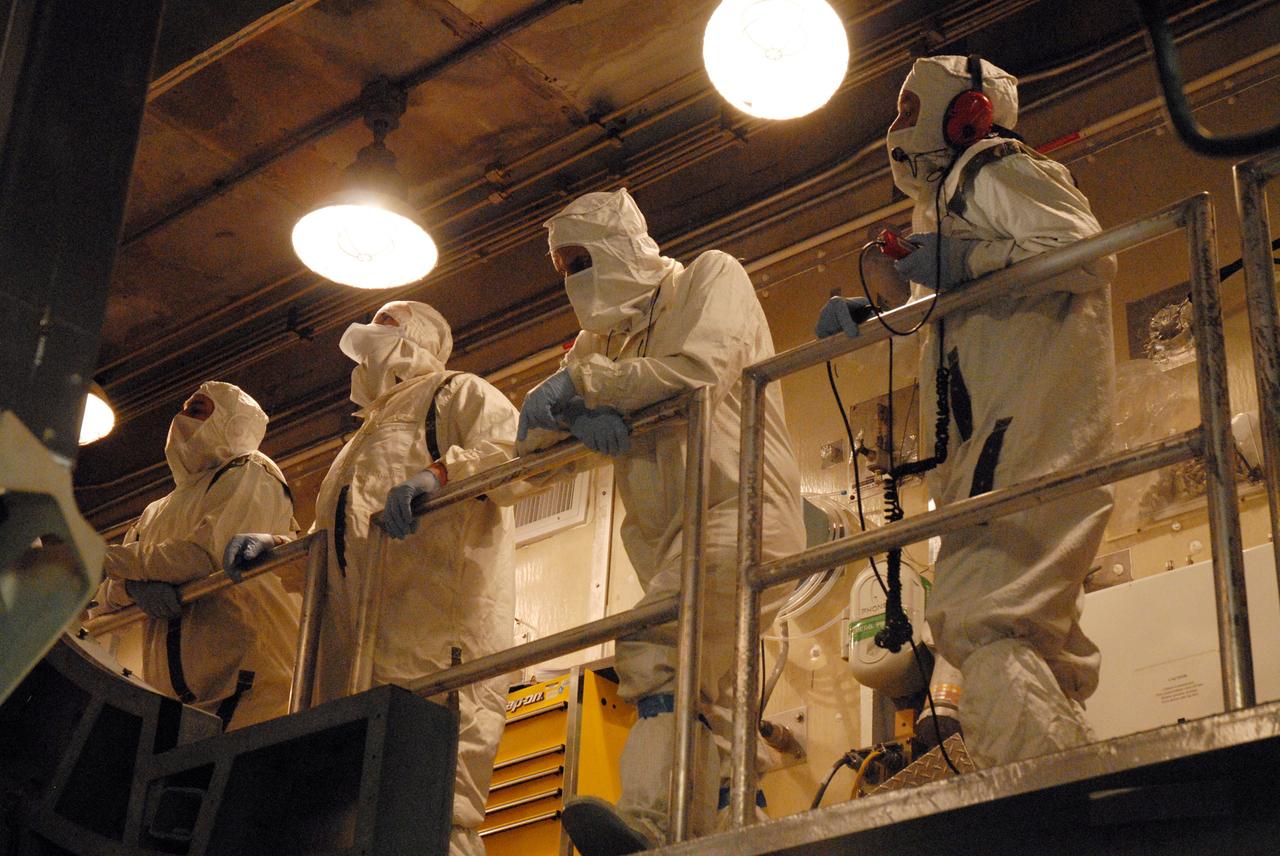 CAPE CANAVERAL, Fla. – Inside the mobile service tower on Launch Pad 17-B at Cape Canaveral Air Force Station in Florida, workers check the progress of the fairing being moved toward the Space Tracking and Surveillance System – Demonstrator spacecraft for encapsulation.  The fairing is a two-part molded structure that fits flush with the outside surface of the rocket and forms an aerodynamically smooth nose cone, protecting the spacecraft during launch and ascent.  STSS Demo is a space-based sensor component of a layered Ballistic Missile Defense System designed for the overall mission of detection, tracking and discriminating ballistic missiles.  STSS is capable of tracking objects after boost phase and provides trajectory information to other sensors. It will be launched by NASA for the Missile Defense Agency between 8 and 8:58 a.m. EDT Sept. 18. Approved for Public Release 09-MDA-4934 (09-22-09) Photo credit: NASA/Cory Huston
