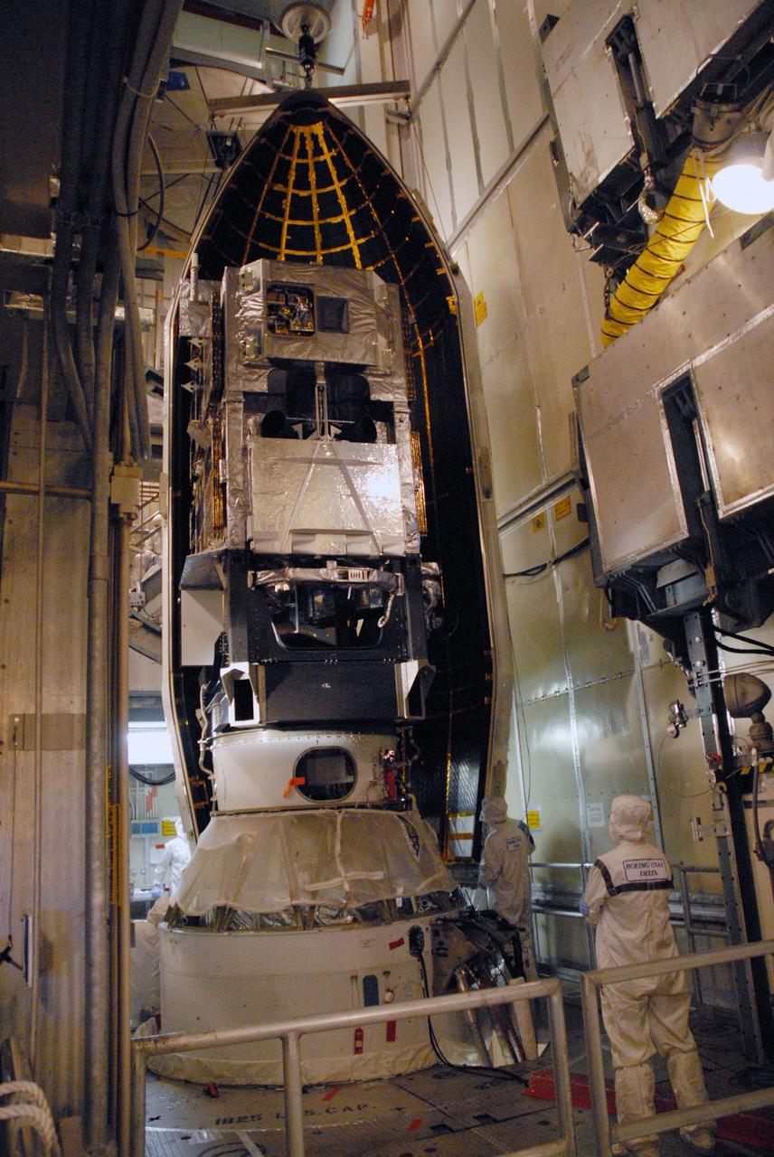 CAPE CANAVERAL, Fla. – Inside the mobile service tower on Launch Pad 17-B at Cape Canaveral Air Force Station in Florida, the first half of the two-part fairing is in place around the Space Tracking and Surveillance System – Demonstrator spacecraft. The fairing is a molded structure that fits flush with the outside surface of the rocket and forms an aerodynamically smooth nose cone, protecting the spacecraft during launch and ascent.  STSS Demo is a space-based sensor component of a layered Ballistic Missile Defense System designed for the overall mission of detection, tracking and discriminating ballistic missiles.  STSS is capable of tracking objects after boost phase and provides trajectory information to other sensors. It will be launched by NASA for the Missile Defense Agency between 8 and 8:58 a.m. EDT Sept. 18. Approved for Public Release 09-MDA-4934 (09-22-09) Photo credit: NASA/Cory Huston